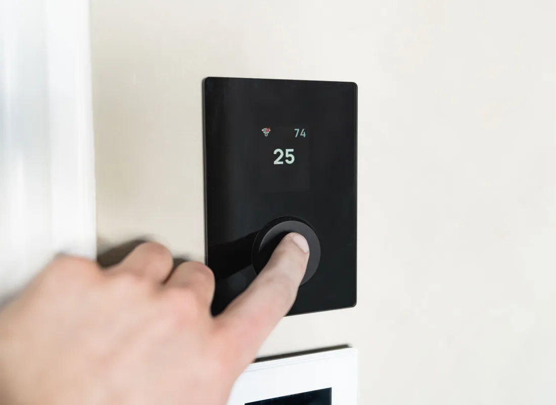 Hand bij een slimme thermostaat