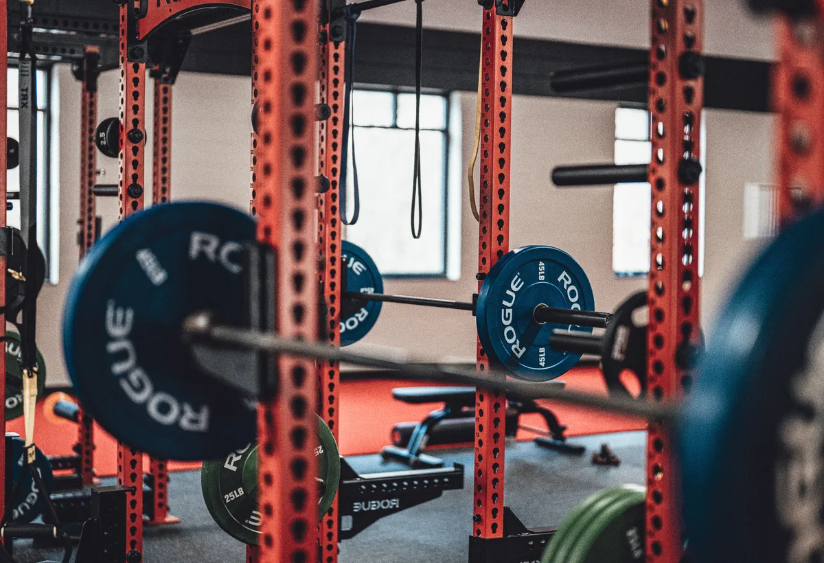 Sporter laadt halterschijven op barbell voor deadlift