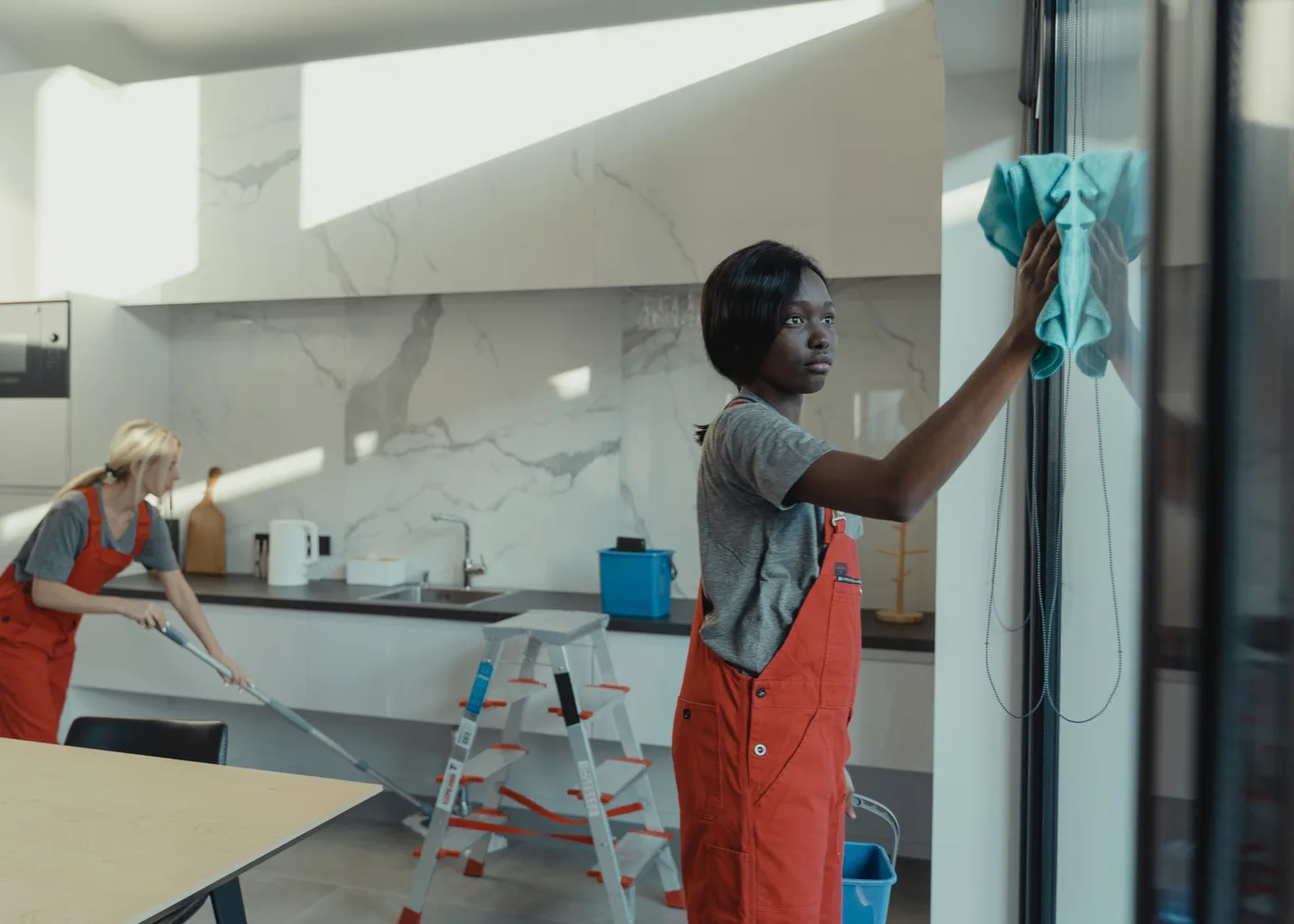 Twee medewerkers maken een moderne kantoorpantry schoon